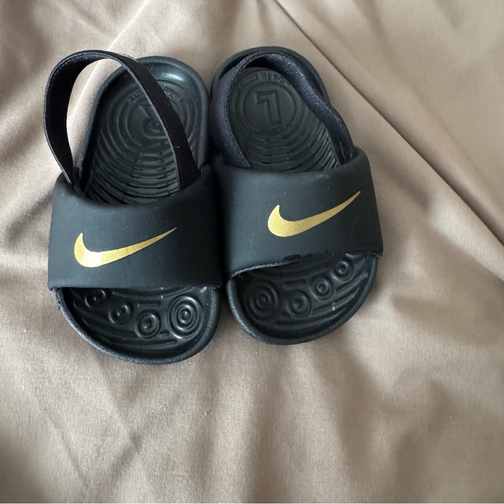 Nike Kids Black Slide Sandals with Gold Swoosh Accent